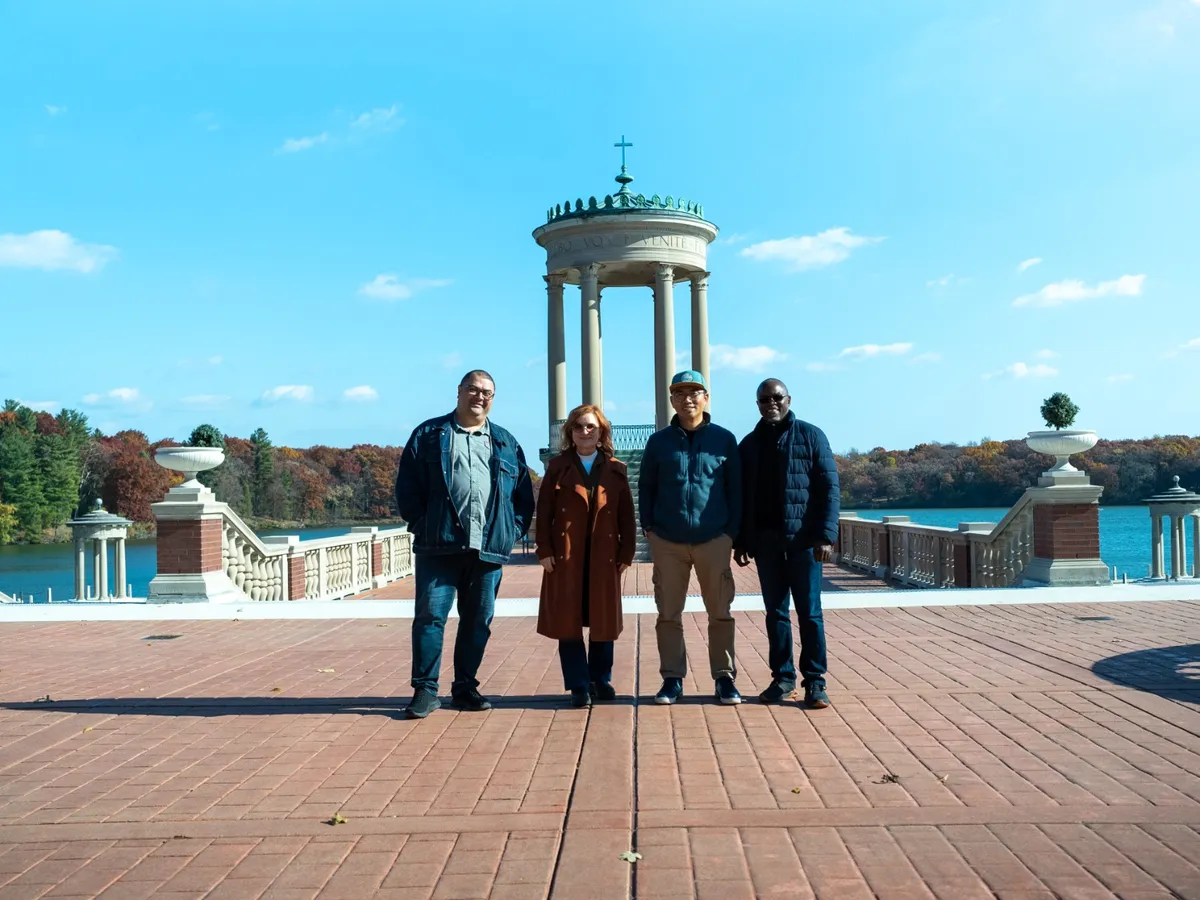 The four Accents co-founders in front of a lakeside gazebo